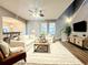 Bright living room featuring a sectional sofa, modern decor, and a staircase at 14521 Tanja King Blvd, Orlando, FL 32828