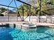 Gorgeous screened pool and hot tub with lush landscaping at 14521 Tanja King Blvd, Orlando, FL 32828