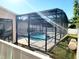 Backyard view showcasing the screened-in pool and spa area surrounded by well-maintained landscaping at 14521 Tanja King Blvd, Orlando, FL 32828