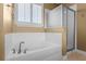 Bright bathroom showcasing a large soaking tub and separate glass-enclosed shower for a relaxing spa-like experience at 14738 Porter Rd, Winter Garden, FL 34787