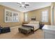 Bedroom with a ceiling fan, carpeted flooring, and plantation shutters at 14738 Porter Rd, Winter Garden, FL 34787