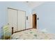 Bedroom with sliding door closet and chair with bright and comfortable furnishings, creating a welcoming retreat at 14738 Porter Rd, Winter Garden, FL 34787