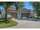 Spacious two-car garage with ample parking and a well-maintained driveway and manicured lawn at 14738 Porter Rd, Winter Garden, FL 34787