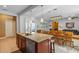 Kitchen island with granite countertops, stainless steel appliances, and open view to the dining area at 14738 Porter Rd, Winter Garden, FL 34787