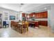 Bright kitchen features a center island, a dining table with seating, and stainless steel appliances at 14738 Porter Rd, Winter Garden, FL 34787