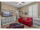 Living room featuring a red sofa, white shelving and a mounted TV offering a stylish and functional space at 14738 Porter Rd, Winter Garden, FL 34787