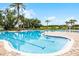 Large community pool featuring ample seating, palm trees, and various water features at 14738 Porter Rd, Winter Garden, FL 34787