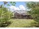 Lush backyard with a screened-in patio, mature trees, and beautiful landscaping at 158 Hickory Stick Ct, Debary, FL 32713