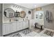 A primary bathroom features a double sink vanity, lots of counter space, and large mirrors at 158 Hickory Stick Ct, Debary, FL 32713