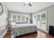 Bright bedroom features a comfortable bed with a plush comforter and large windows at 158 Hickory Stick Ct, Debary, FL 32713
