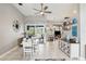 Bright dining area with tile flooring, white table and chairs, and a view of the outdoor space at 158 Hickory Stick Ct, Debary, FL 32713