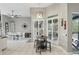 Bright eating area with a table, stools, shuttered windows and view of the dining area and pool at 158 Hickory Stick Ct, Debary, FL 32713