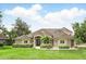 Charming home with manicured lawn and tasteful landscaping, enhancing curb appeal with a welcoming entrance and inviting atmosphere at 158 Hickory Stick Ct, Debary, FL 32713