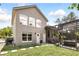 Beautiful home exterior with a screened-in patio, manicured lawn, and arched windows at 158 Hickory Stick Ct, Debary, FL 32713