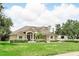 Beautiful home featuring lush green lawn, mature trees, and tasteful landscaping, creating a serene and inviting curb appeal at 158 Hickory Stick Ct, Debary, FL 32713
