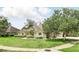 Well-maintained home featuring lush lawn and mature landscaping, creating a serene and inviting curb appeal with an inviting facade at 158 Hickory Stick Ct, Debary, FL 32713
