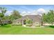 Beautiful home with lush green lawn, mature trees, and tasteful landscaping, creating a serene and inviting curb appeal at 158 Hickory Stick Ct, Debary, FL 32713