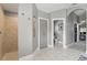 A hallway featuring neutral tile flooring, a walk in shower, and closet at 158 Hickory Stick Ct, Debary, FL 32713