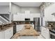 A beautifully kitchen features stainless appliances, granite countertops, tile backsplash, and center island at 158 Hickory Stick Ct, Debary, FL 32713