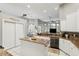 An open-concept kitchen featuring granite countertops, stainless appliances, and access to the backyard at 158 Hickory Stick Ct, Debary, FL 32713