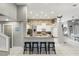 Modern kitchen featuring a breakfast bar with granite countertops, stylish stools, and stone accent wall at 158 Hickory Stick Ct, Debary, FL 32713