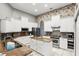 Spacious kitchen features stainless appliances, white cabinetry, granite countertops, and center island at 158 Hickory Stick Ct, Debary, FL 32713