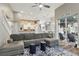 Spacious living room with a large sectional, tile floors, and view of the modern kitchen and lanai at 158 Hickory Stick Ct, Debary, FL 32713