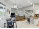 Cozy living area with staircase, eat-in table, and a view of the kitchen with stainless steel appliances at 158 Hickory Stick Ct, Debary, FL 32713