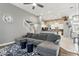 Open living room with a large sectional couch, staircase, and a view of the modern kitchen at 158 Hickory Stick Ct, Debary, FL 32713