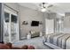 A main bedroom boasts backyard access, a ceiling fan, bench, and sliding glass doors at 158 Hickory Stick Ct, Debary, FL 32713