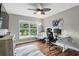 Bright home office space with a large window, desk, and comfortable seating area at 158 Hickory Stick Ct, Debary, FL 32713