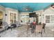 Covered patio with a ceiling fan, TV, and outdoor dining set at 158 Hickory Stick Ct, Debary, FL 32713