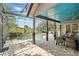 Screened-in pool area with a covered patio, outdoor seating, and lush landscaping at 158 Hickory Stick Ct, Debary, FL 32713
