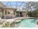 Swimming pool with outdoor lounge area, tropical plants, and screened enclosure at 158 Hickory Stick Ct, Debary, FL 32713