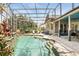 Swimming pool with a waterfall feature, steps, and screened enclosure at 158 Hickory Stick Ct, Debary, FL 32713