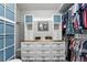 Organized walk-in closet with drawers, shelves and a hanging rod system for optimal clothing storage at 158 Hickory Stick Ct, Debary, FL 32713