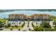 A breathtaking aerial view captures the condo complex, parking area, and scenic lake surroundings at 16300 County Road 455 # 606, Montverde, FL 34756