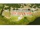 Stunning aerial view of the condo complex featuring a pool, parking, and lush green landscaping at 16300 County Road 455 # 606, Montverde, FL 34756