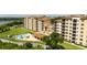Condominium complex featuring a community pool, outdoor seating, and well-manicured grounds set against a green landscape at 16300 County Road 455 # 606, Montverde, FL 34756