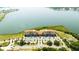 Beautiful aerial shot of condos overlooking the lake, with a pool, parking area, and surrounding trees at 16300 County Road 455 # 606, Montverde, FL 34756