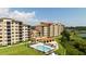 Condominium complex featuring a community pool, outdoor seating, and well-manicured grounds set against a green landscape at 16300 County Road 455 # 606, Montverde, FL 34756