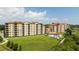 Aerial view of complex highlighting pool, expansive lawn, and prime location, plus an arrow showing the listed unit at 16300 County Road 455 # 606, Montverde, FL 34756