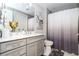 Stylish bathroom featuring a gray vanity, modern fixtures, and a shower with a decorative gray and white curtain at 16300 County Road 455 # 606, Montverde, FL 34756