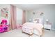 Charming bedroom with pink accents, featuring a decorative headboard and playful décor, creating a cozy space at 16300 County Road 455 # 606, Montverde, FL 34756