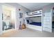 This bedroom features a bunkbed and an ensuite bathroom with modern fixtures and neutral color palettes at 16300 County Road 455 # 606, Montverde, FL 34756