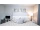 Bedroom with cushioned headboard, mirrored wall decor, and work desk at 16300 County Road 455 # 606, Montverde, FL 34756
