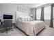 Bedroom with cushioned headboard, mirrored wall decor, work desk and a large window at 16300 County Road 455 # 606, Montverde, FL 34756