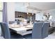Bright dining area with modern decor and an open view of the kitchen and living room at 16300 County Road 455 # 606, Montverde, FL 34756
