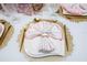 Elegantly arranged dining table features gold cutlery, ornate placemats, and a stylishly folded napkin on a pristine white plate at 16300 County Road 455 # 606, Montverde, FL 34756