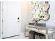 An elegant entryway featuring a stylish console table, decorative mirror, and modern accents at 16300 County Road 455 # 606, Montverde, FL 34756